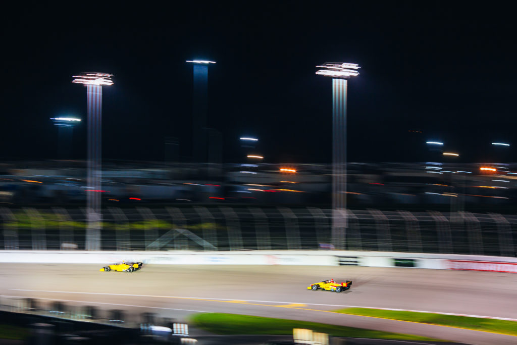 night photo of racecars on the track at the INDY NXT race in Madison IL